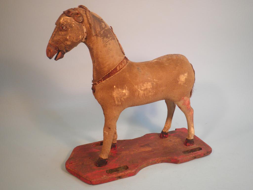 Appraisal: A thC pull-a-long toy horse covered in pony skin the