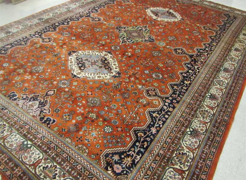 Appraisal: SIGNED AND HAND KNOTTED ORIENTAL CARPET Indo-Persian triple geometric medallion