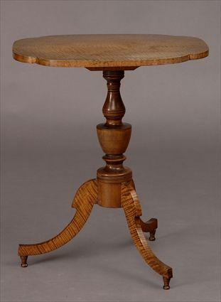 Appraisal: LATE FEDERAL FIGURED MAPLE TRIPOD CANDLESTAND The quatrefoil tilt top