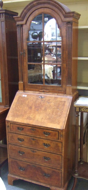 Appraisal: A th century walnut bureau bookcase the arched top with