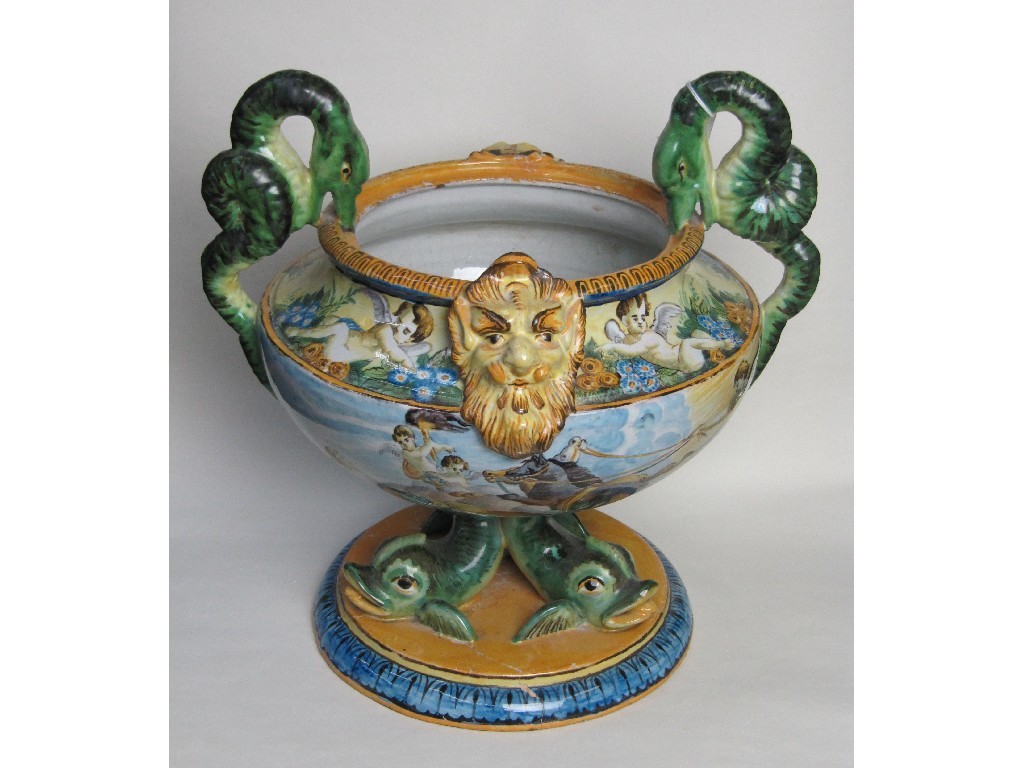 Appraisal: Cantagalli style faience twin handled bowl supported on three dolphins