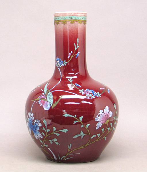 Appraisal: A Chinese flamb red glazed porcelain stick neck vase With