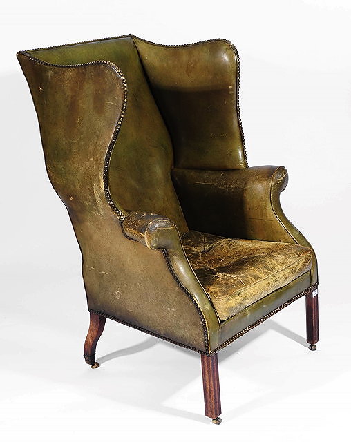 Appraisal: A George III mahogany wing chairwith shaped back and upholstered