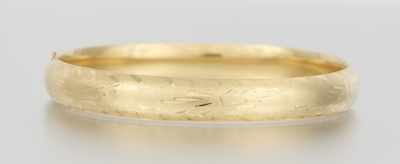 Appraisal: A Ladies' Engraved Gold Bangle Bracelet k yellow gold hinged