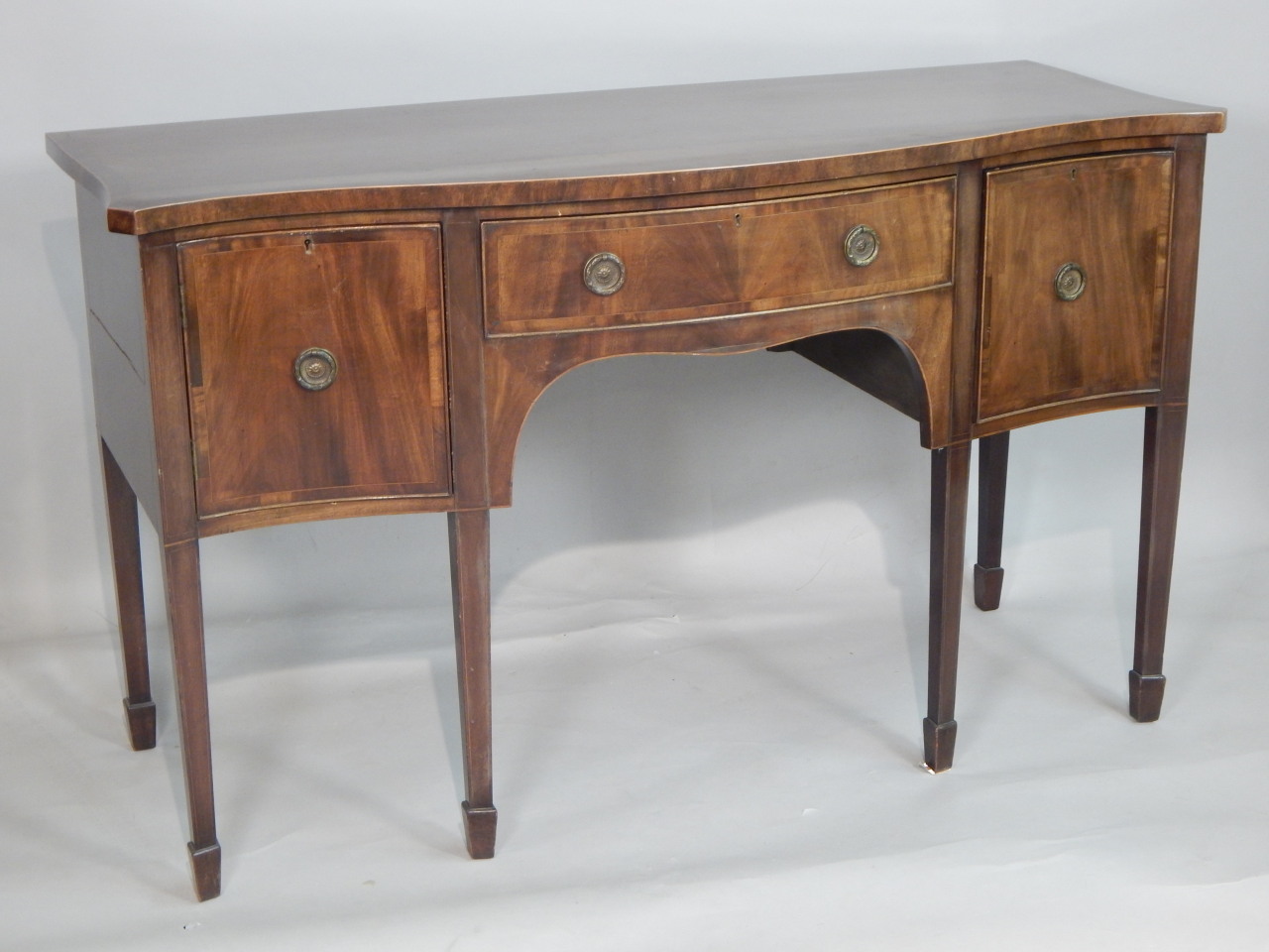 Appraisal: A mahogany serpentine fronted sideboard in George III style the