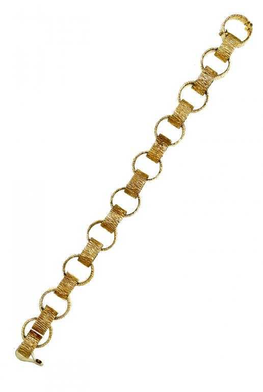 Appraisal: A GOLD BRACELET composed of bark textured rings ct London