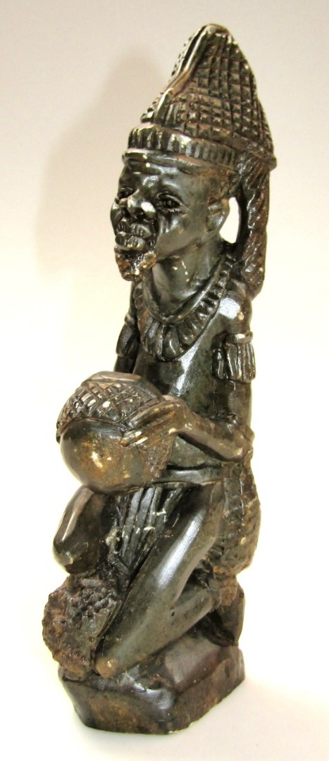 Appraisal: A thC African polished stone tribal beaded figure sparsely dressed