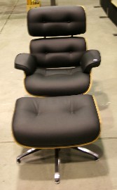 Appraisal: A Ray and Charles Eames armchair and footstool in black