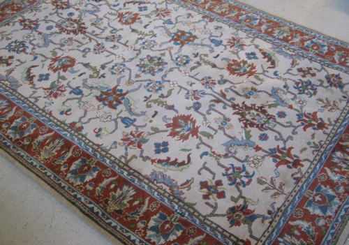 Appraisal: HAND KNOTTED ORIENTAL WOOL CARPET Indo-Isfahan overall floral decoration on