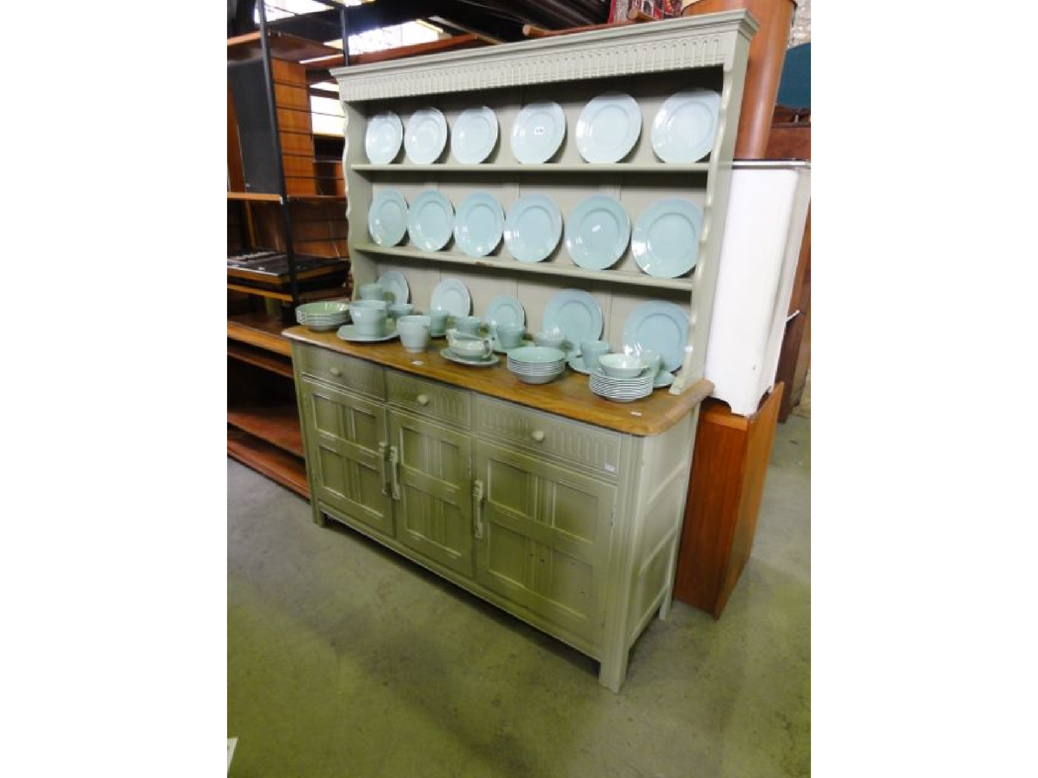 Appraisal: A reproduction oak dresser with later green painted and distressed