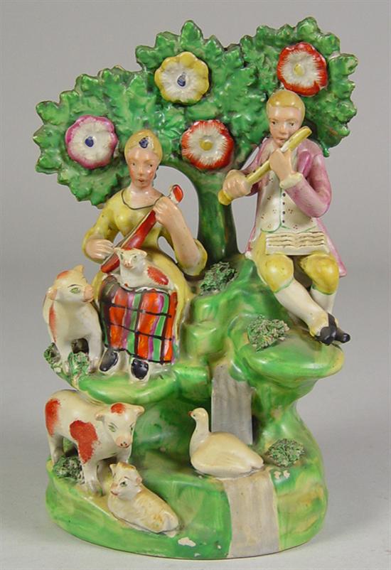 Appraisal: Staffordshire Figure of Man Woman Mid th Century In landscape