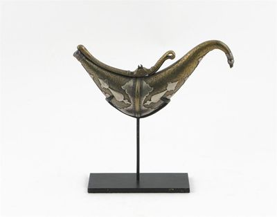 Appraisal: An Indian silver mounted brass powder horn the body delicately