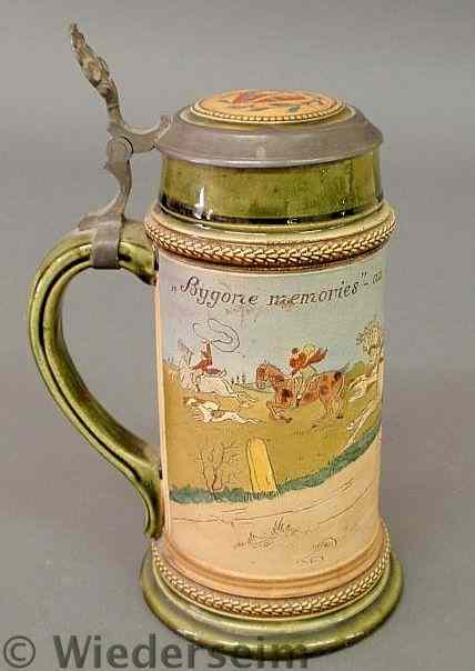 Appraisal: German porcelain beer stein with a caricature carriage and foxhunting