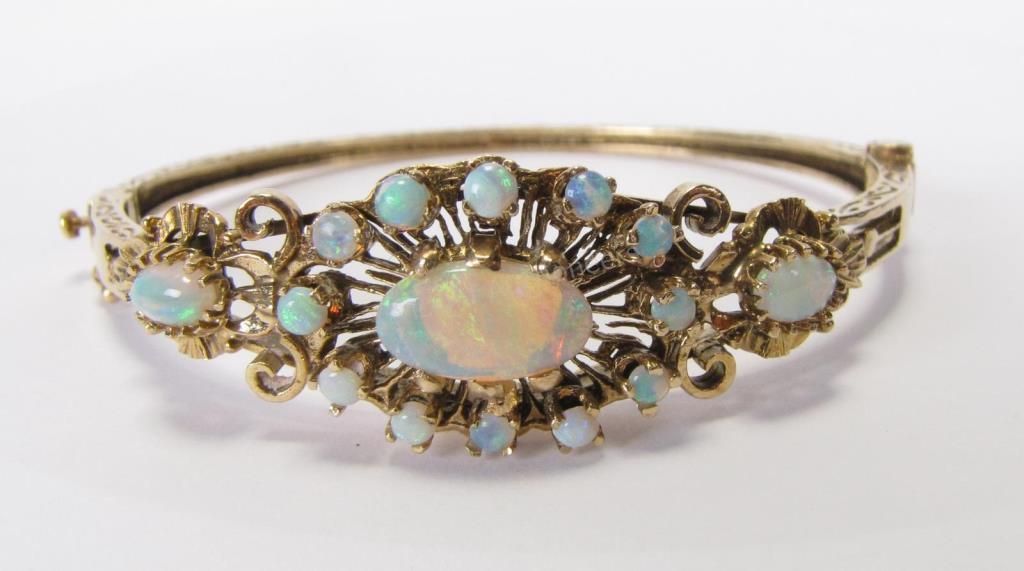 Appraisal: An K yellow gold tested unmarked hinged opal bangle bracelet