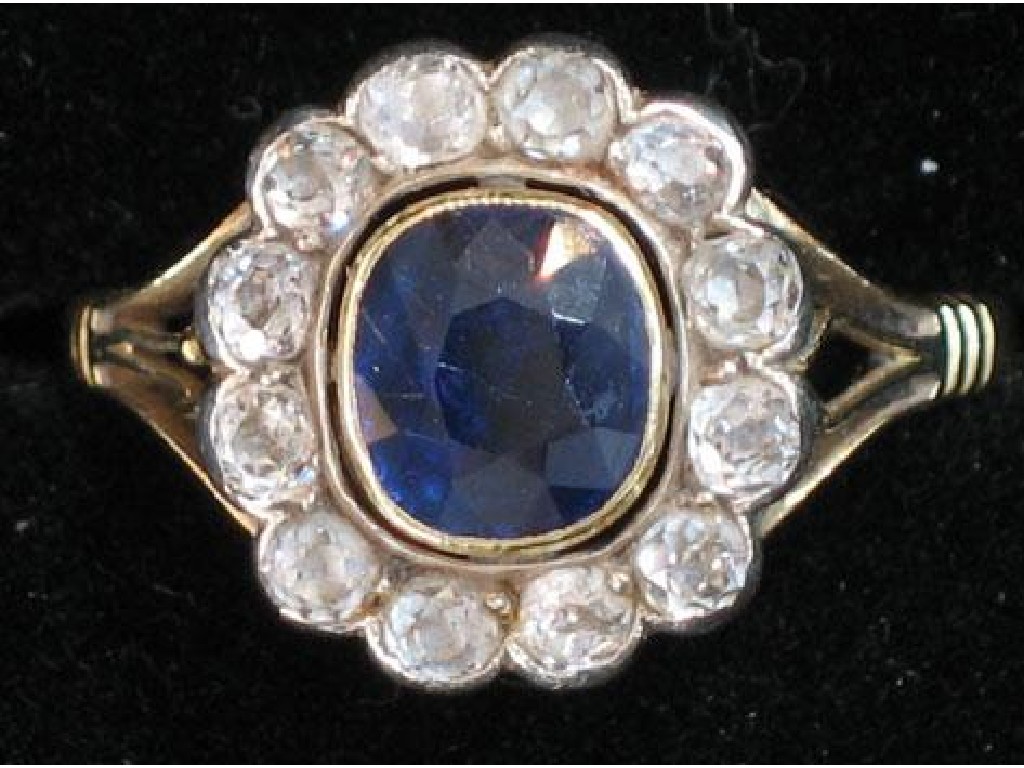 Appraisal: A SAPPHIRE AND DIAMOND CLUSTER RING the central cushion-cut sapphire