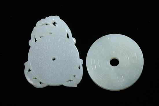 Appraisal: TWO CHINESE CELADON JADE BI-FORM PENDANTS - in diam