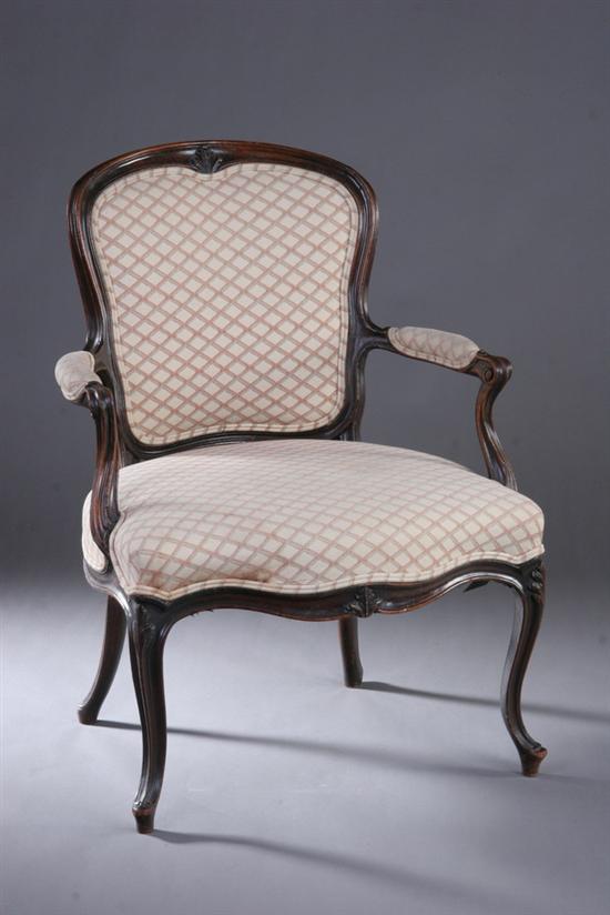 Appraisal: LOUIS XV STYLE PROVINCIAL CARVED FRUITWOOD FAUTEUIL early th century