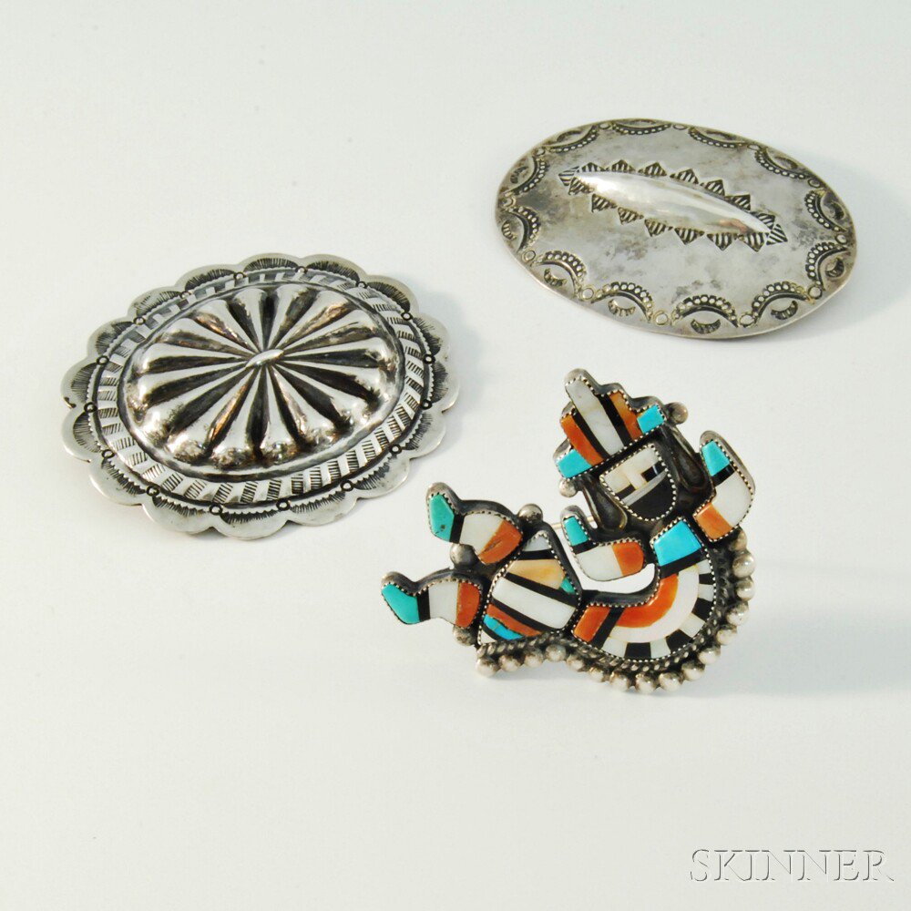 Appraisal: Three Native American Brooches th century two ovoid silver-plated brooches