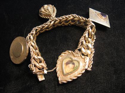 Appraisal: Heavy link yellow gold charm bracelet Set with four charms