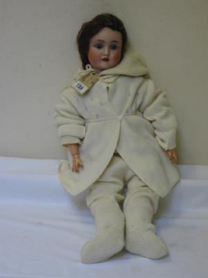 Appraisal: A German bisque head doll with blue glass sleeping eyes