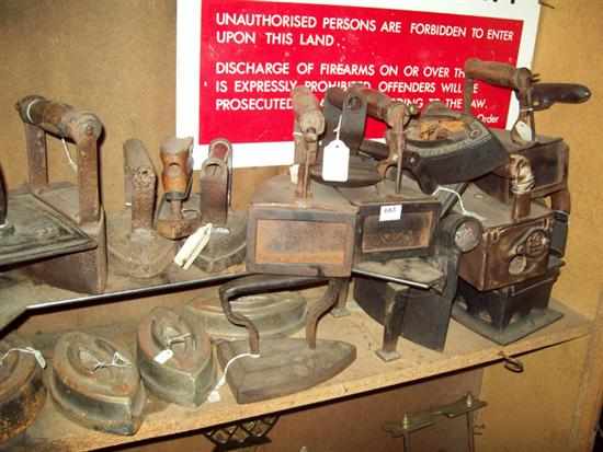 Appraisal: A SHELF OF VICTORIAN CAST IRON IRONS AND ONE ENAMEL