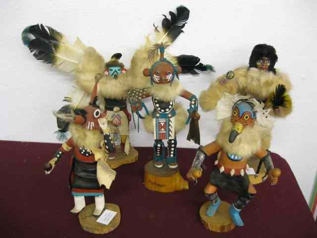 Appraisal: Indian Figurines carved painted wood with leather feather decoration ''