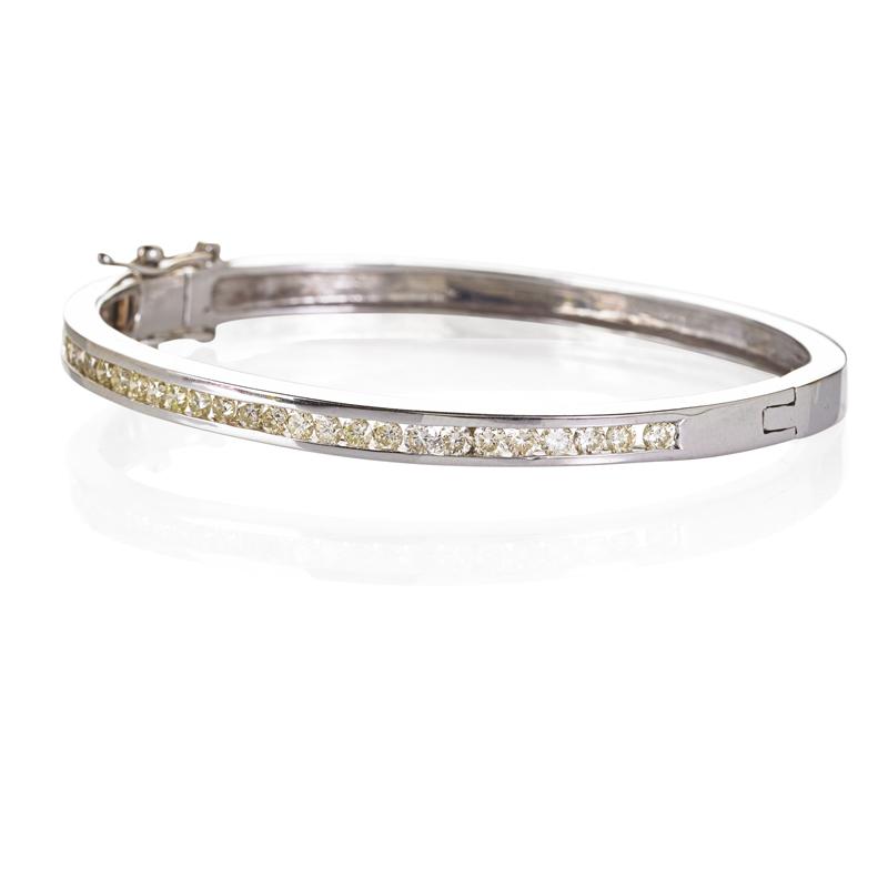 Appraisal: DIAMOND K WHITE GOLD HINGED BANGLE BRACELET The top channel