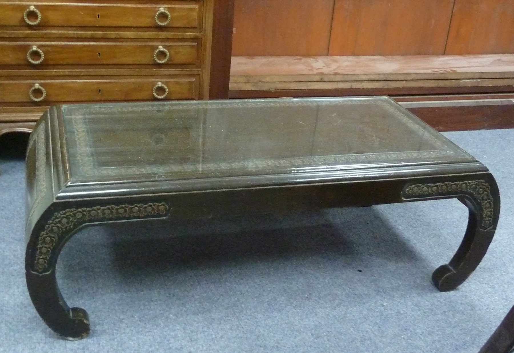 Appraisal: An Oriental ebonised table on crescent end supports cm wide