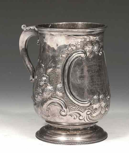 Appraisal: A GEORGE III BALUSTER SHAPED SILVER TANKARD with chased foliate