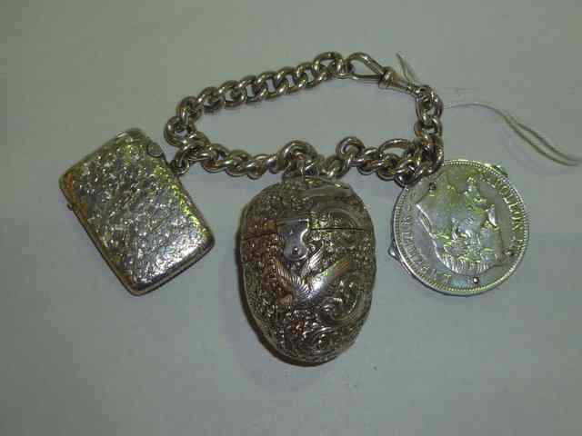 Appraisal: A SILVER CHAIN together with a silver vesta a white