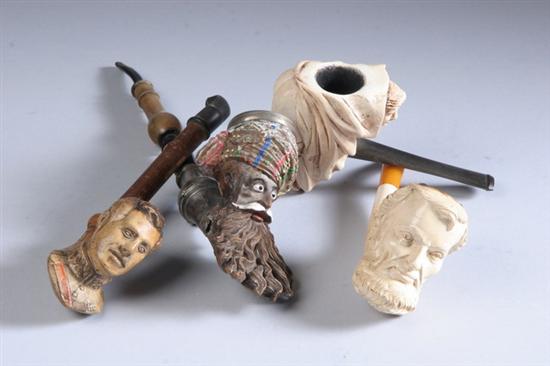 Appraisal: FOUR FIGURAL WHIMSICAL PIPES One carved Meerschaum of Abraham Lincoln