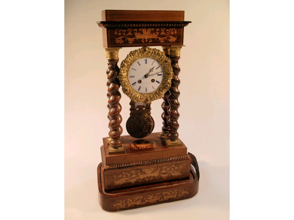 Appraisal: A thC French rosewood portico clock the enamelled eight-day movement