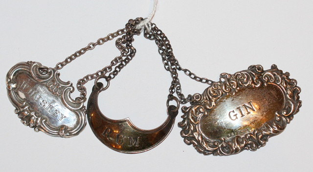 Appraisal: A PRESSED OVAL SILVER DECANTER LABEL with scrolled border engraved