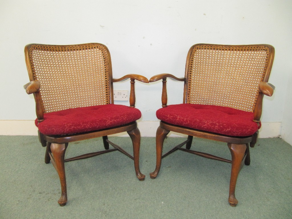 Appraisal: A pair of bergere armchairs with scrolling arms and raised