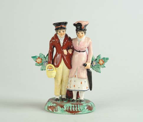 Appraisal: STAFFORDSHIRE FIGURAL GROUP OF MAN AND WOMAN Man on left