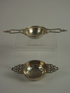 Appraisal: TEA STRAINERS - Two sterling tea strainers with two handles