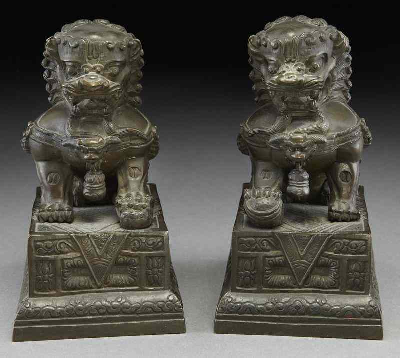 Appraisal: Pr Chinese Qing bronze foo lions with free bells dropped