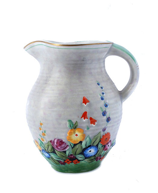 Appraisal: A Crown Devon polychrome jug sdecorated with summer flowers cm