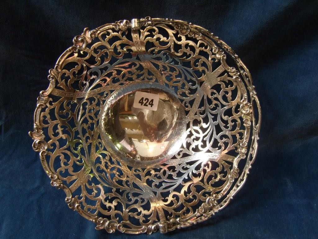 Appraisal: An open silver basket of circular form with loop handle