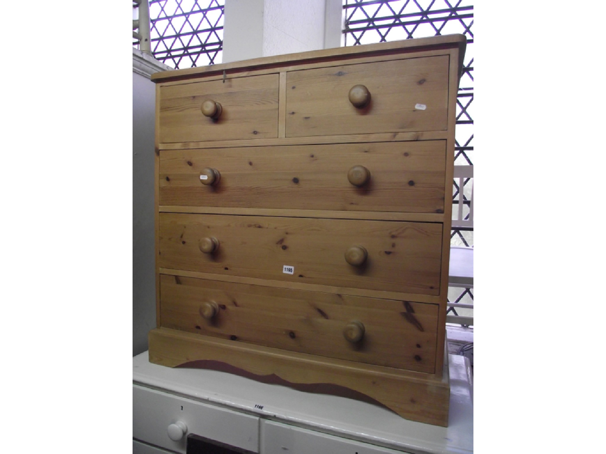 Appraisal: A traditional pine chest of three long and two short