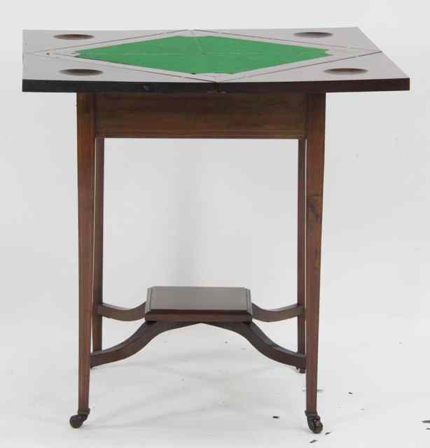 Appraisal: An Edwardian envelope card table the crossbanded top enclosing a