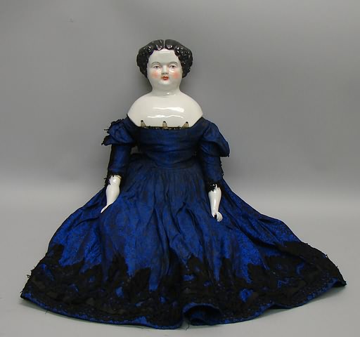 Appraisal: Unmarked 's china head doll with centerpart black hair blue