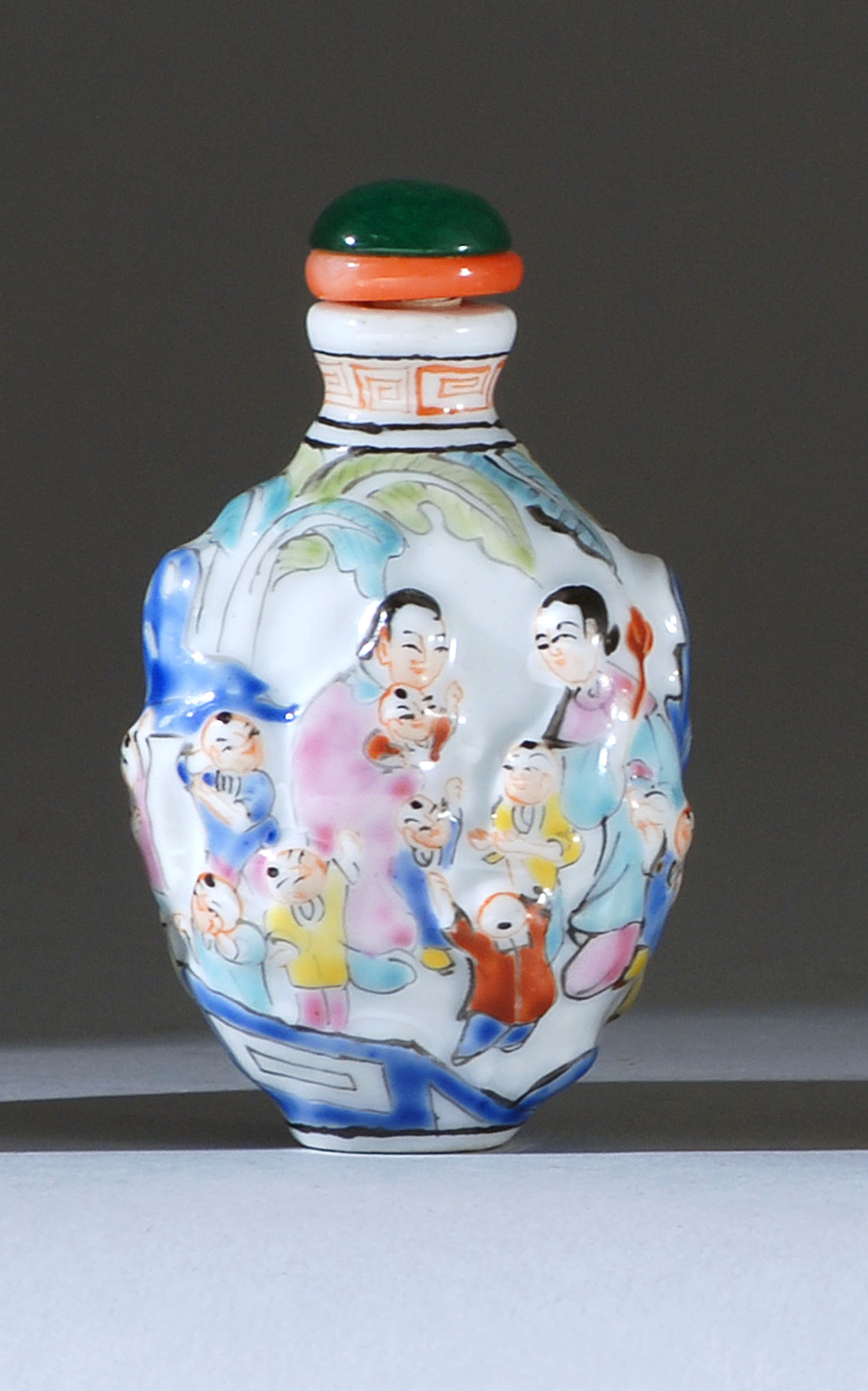 Appraisal: PORCELAIN SNUFF BOTTLE Circa In spade shape with relief polychrome