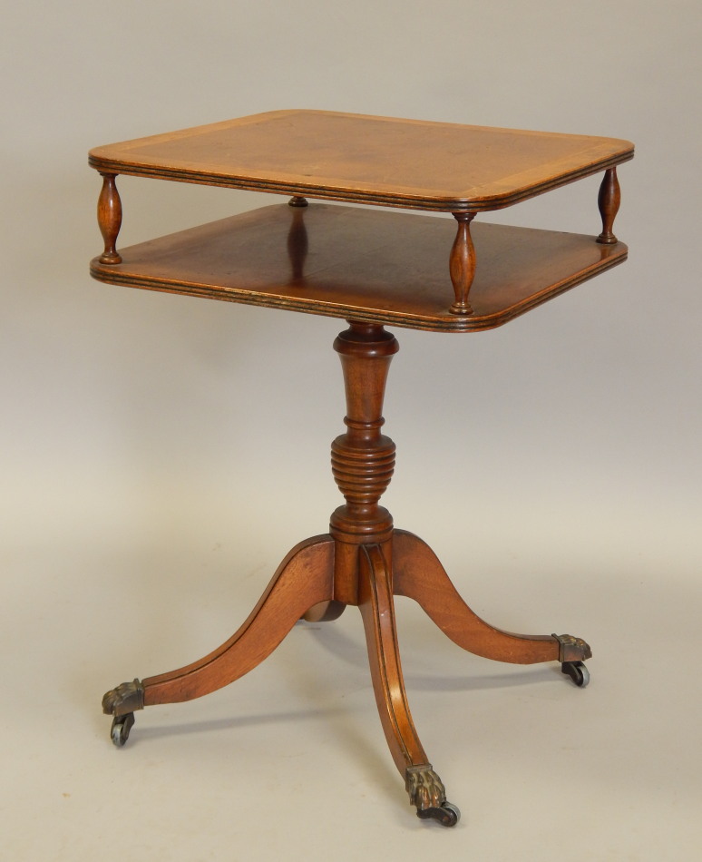 Appraisal: A reproduction yew veneered two tier table on turned column