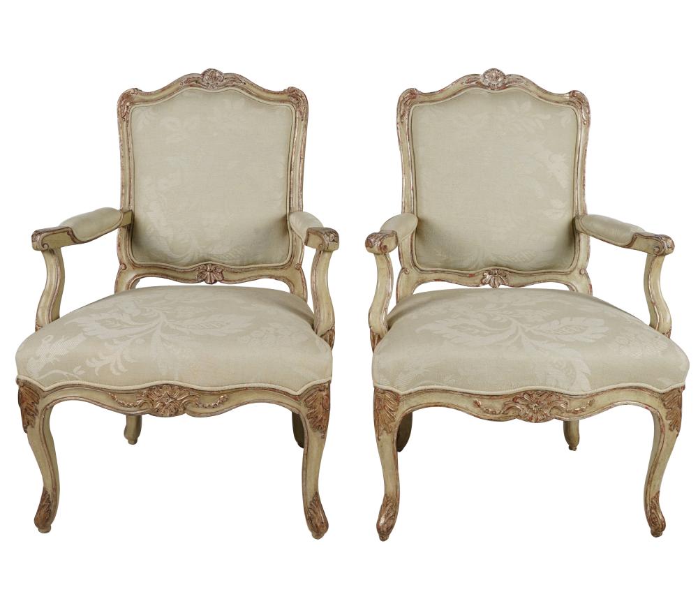 Appraisal: PAIR OF ROCOCO STYLE PAINTED OPEN ARMCHAIRScovered with off-white fabric