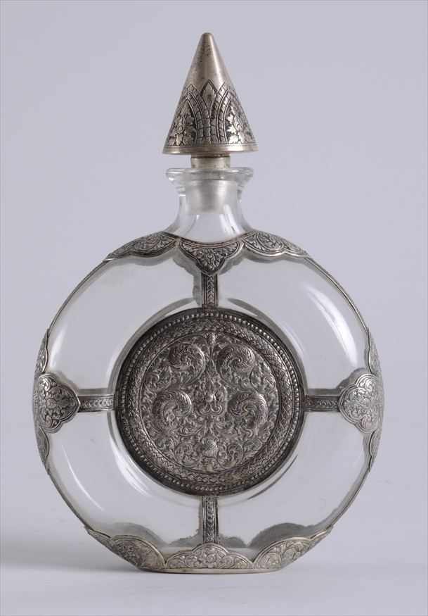 Appraisal: TIBETAN SILVER-MOUNTED GLASS MOON FLASK AND STOPPER Centered by rondels