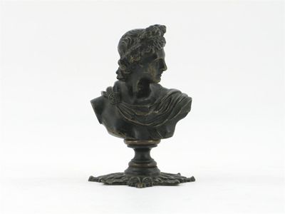 Appraisal: A bronze bust of a Roman on draped leaf base