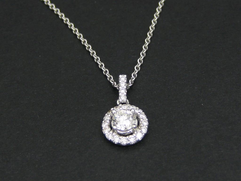 Appraisal: A Diamond Pendant the principle brilliant-cut stone claw-set within a