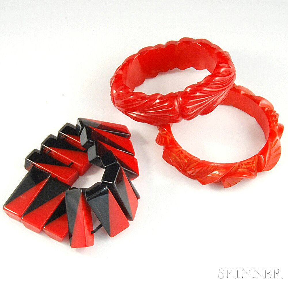 Appraisal: Three Bakelite Bracelets two carved red bangles and a black