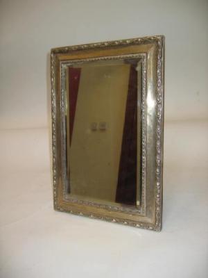 Appraisal: AN EDWARDIAN EASEL MIRROR Birmingham the rectangular moulded frame embossed